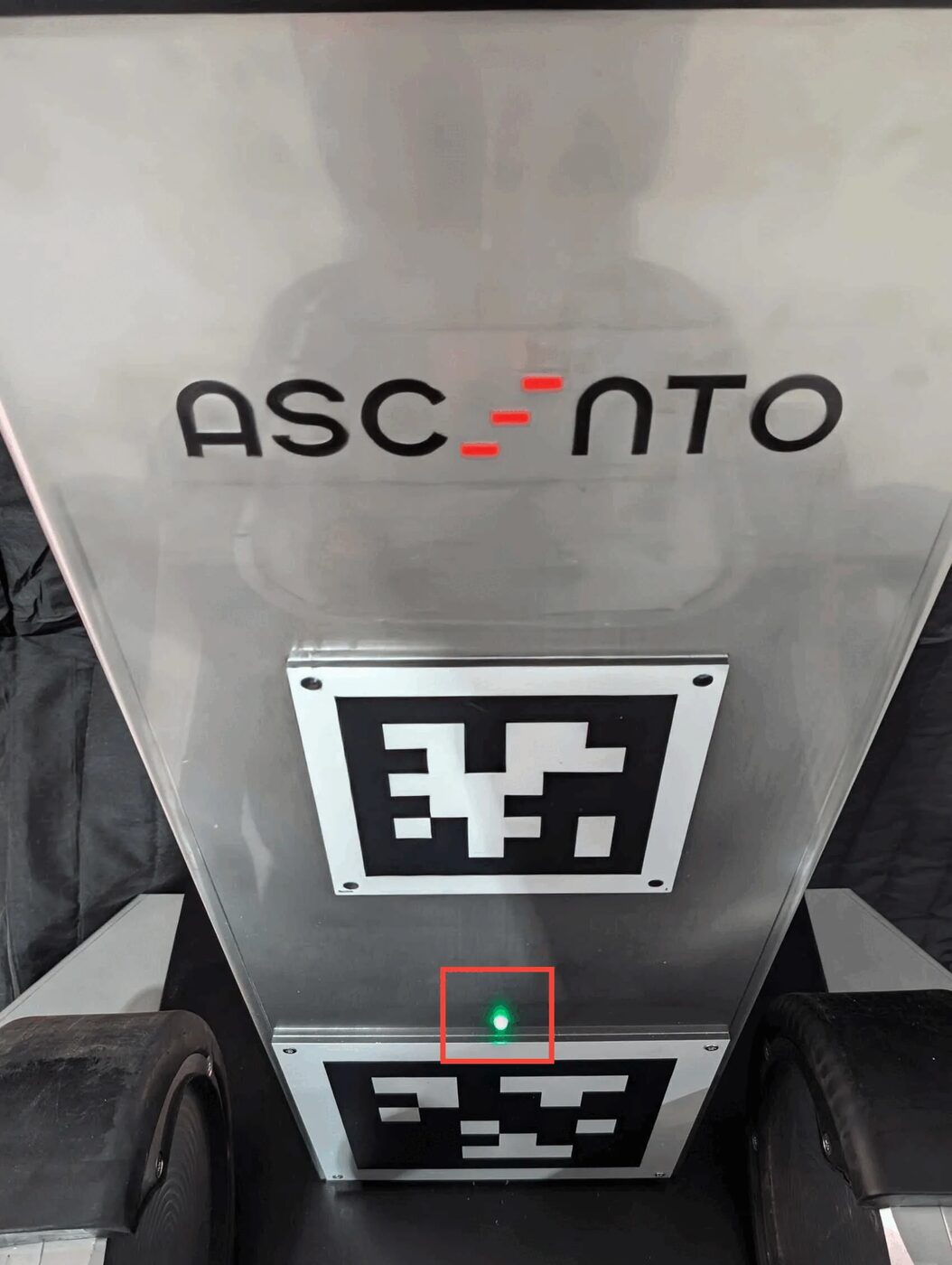 Ascento docking station LED glowing green, indicating the robot is fully charged