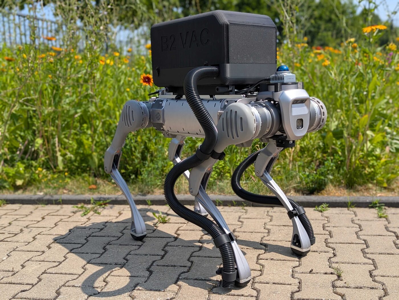 B2 Vacc autonomous vacuum demo platform, outdoors on a paved path
