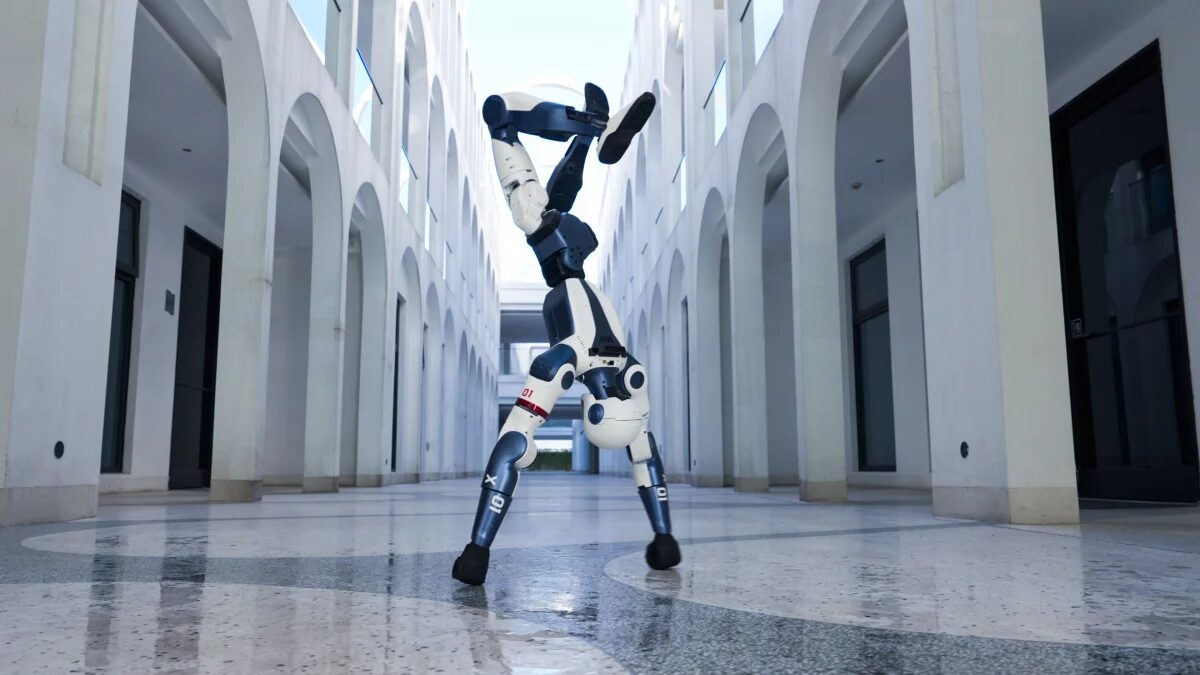 Unitree R1 performing an agile handstand-style motion indoors